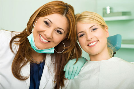 A dentist in Redmond, WA smiling with a patient